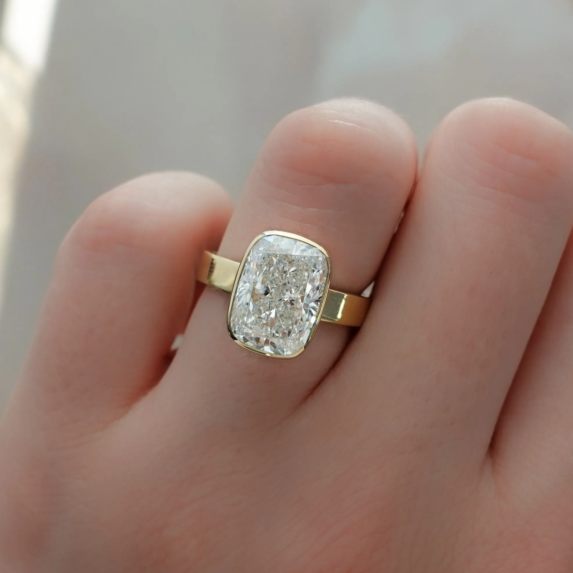 Finest Bezel Set Engagement Ring With Elongated Cushion Cut Diamond